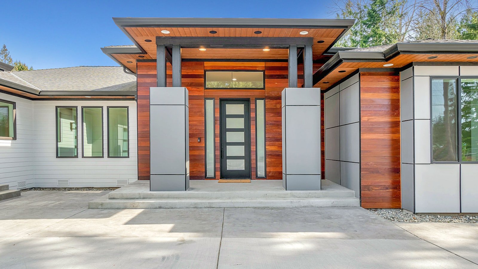 A modern home exterior clad in warm timber with a covered entry.